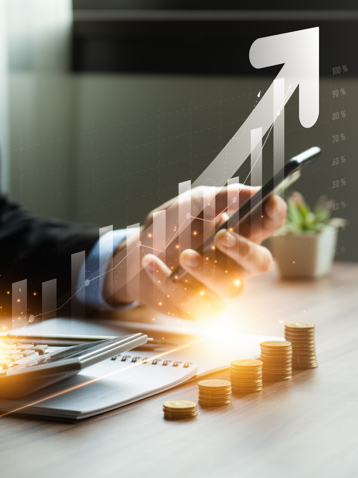 Hand on a phone above a desk with stacked coins and a finance growth overlay