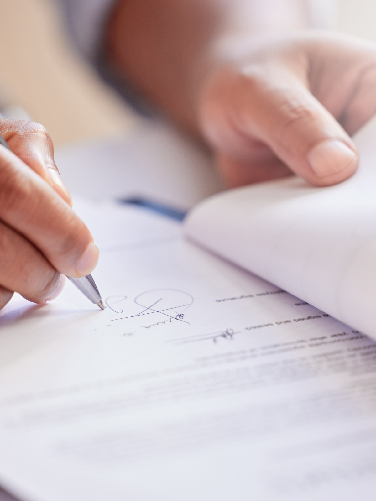 Close-up of a buyer signing a Best World purchase contract by hand