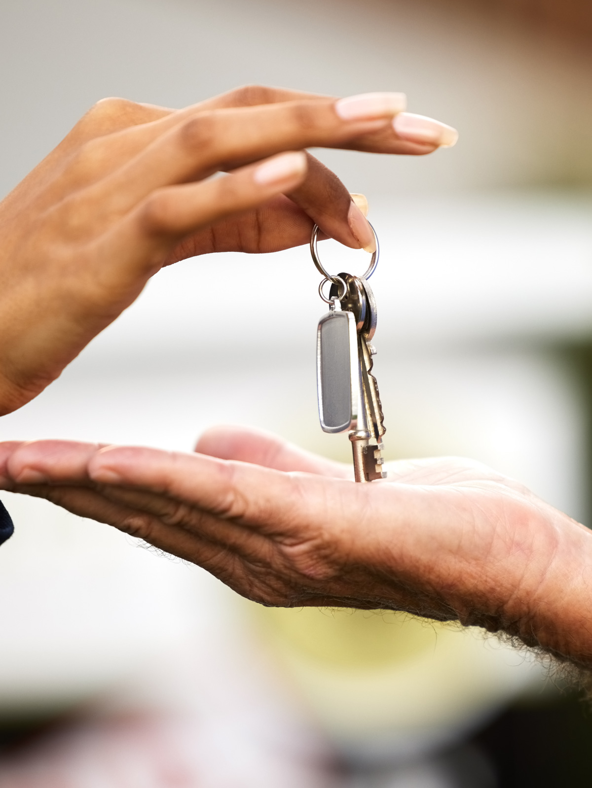 Best World keys handed from one open palm to another at handover
